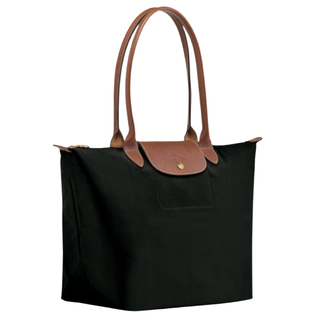 Black tote bag with brown leather handles on a white background
